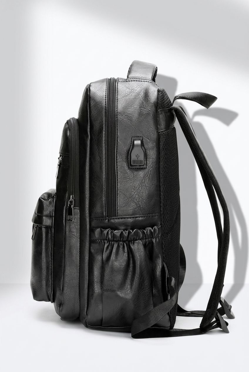 Male model holding NordEdge leather crossbody bag black