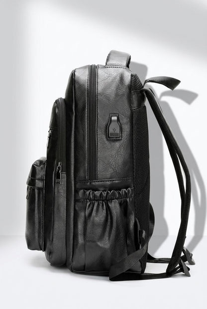 Male model holding NordEdge leather crossbody bag black