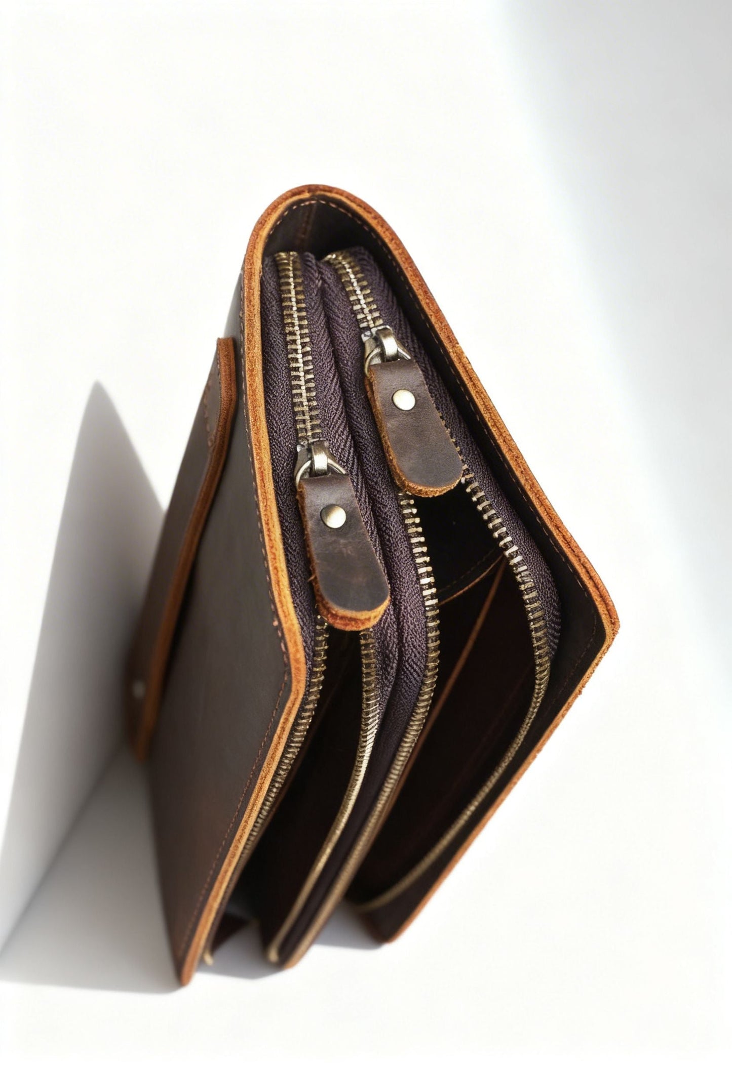 Man holding a genuine leather wrist wallet, lifestyle shot