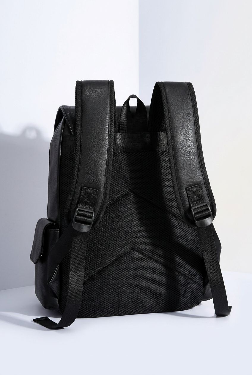 Close-up detail of the durable zipper and textured PU leather material on the men's laptop backpack.